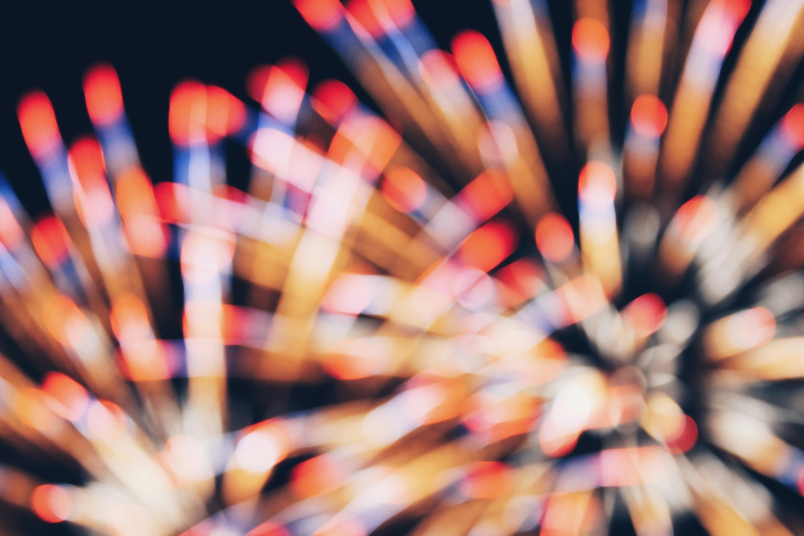 Colorful blurred fireworks create an abstract and festive night scene.